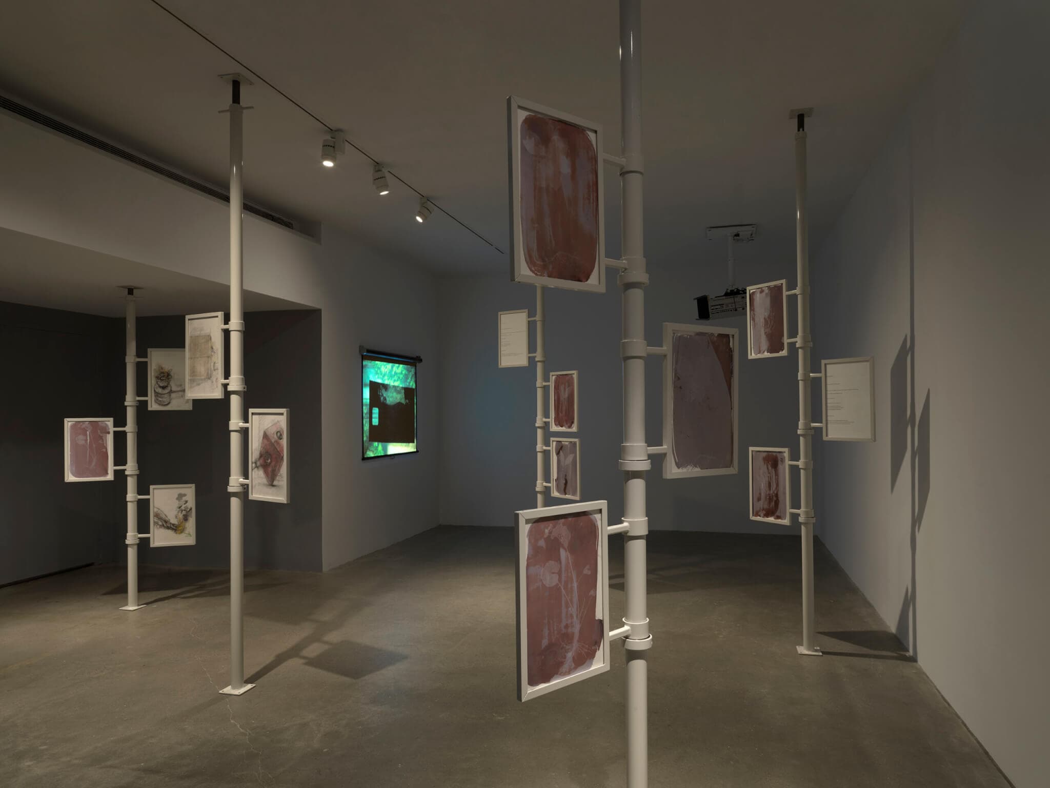 Artwork is installed flag-like across five floor-to-ceiling poles in Sophie Friedman-Pappas and TJ Shin's installation.